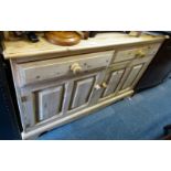 A pine sideboard, with a raised back, the base of two drawers, above two panelled cupboards, 97cm hi