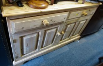 A pine sideboard, with a raised back, the base of two drawers, above two panelled cupboards, 97cm hi