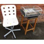 A group of furniture, comprising stool, office chair, and a Neff food cover.