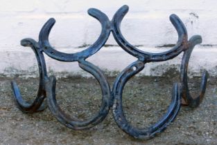 A garden wall basket formed as six conjoined horseshoes, 45cm wide.