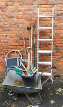 A wheelbarrow, together with garden tools, step ladder, etc.