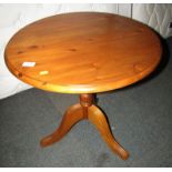 A Ducal pine occasional table, with circular top above tripod base, 60cm high, the top 60cm diameter