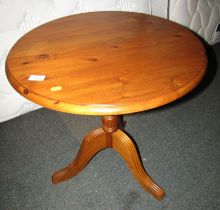 A Ducal pine occasional table, with circular top above tripod base, 60cm high, the top 60cm diameter