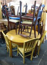 A pine extending kitchen table, of circular top on turned tapering legs, 71cm high, the top 119cm di