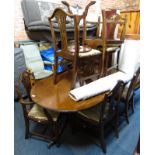 A mahogany and cross banding extending twin pedestal dining table, with oval top, 75cm high, the top
