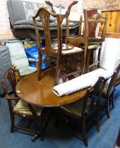 A mahogany and cross banding extending twin pedestal dining table, with oval top, 75cm high, the top