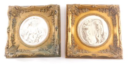 Two similar marble effect resin plaques, each modelled in the form of figures within a gilt frame, 3