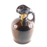 A Royal Doulton whisky flagon, the top moulded with a figure, the base printed with a similar figure
