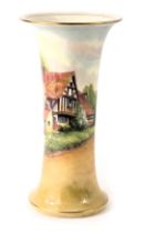 A Royal Worcester porcelain wasted cylindrical vase, painted with a cottage within landscape, signed