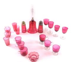 A cranberry tinted glass bell, with clear handle, various cranberry tinted custard cups, wine glasse