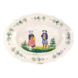A 19thC Quimper oval Faience platter, decorated with gentleman with a walking stick, a lady with a p