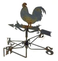 A 20thC black painted weather vane, decorated with a chicken, 38cm wide.