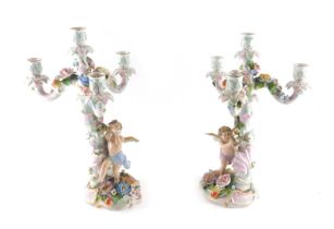 A pair of late 19th/early 20thC German flower encrusted figural four branch candelabra, each decorat