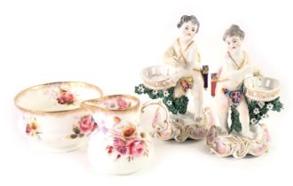 Four items of ceramics, comprising two continental porcelain figures, of children carrying baskets,