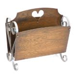 A silver painted wrought iron and oak two division magazine rack, 45cm wide.