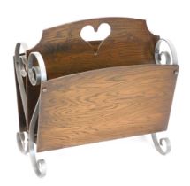 A silver painted wrought iron and oak two division magazine rack, 45cm wide.
