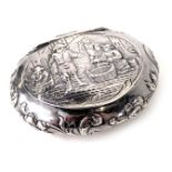 A continental white metal trinket box, of oval design with an embossed detail of fisherman, and scro
