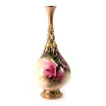 A Royal Worcester porcelain bottle shaped vase, painted with roses and with elaborate gilt design to