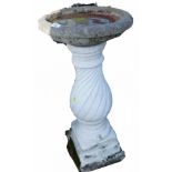 A reconstituted stone and painted white bird bath, on twist stem pedestal and square foot, 80cm high