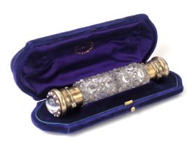 A French gilt metal and cut glass scent bottle by Leuchars and son , with twin ends set with rock cr