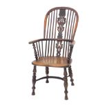A mid 19thC yew, ash and elm high back Windsor chair, with a pierced splat, solid seat, on turned le