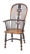 A mid 19thC yew, ash and elm high back Windsor chair, with a pierced splat, solid seat, on turned le