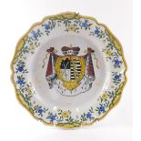 An early 20thC Geo Martell French faience armorial plate, polychrome decorated with blue and yellow
