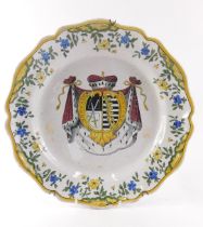 An early 20thC Geo Martell French faience armorial plate, polychrome decorated with blue and yellow