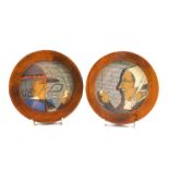 A pair of Paul Fouillen Quimper faience cabinet plates, each carved depicting lady and gentleman smo