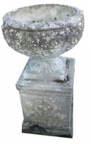 A reconstituted stone garden urn, on a square foot with wreaths, 73cm high, 41cm wide.