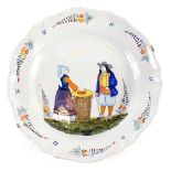 A 19thC large Quimper Faience plate, decorated with two figures, etc., stamped to underside HB, 29.5