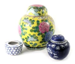 Three items of oriental ceramics, comprising a prunus pattern ginger jar and cover, 10cm high, a yel