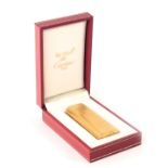 A Must De Cartier gold plated lighter, serial number 89578, boxed with warrantee certificate.
