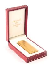 A Must De Cartier gold plated lighter, serial number 89578, boxed with warrantee certificate.