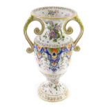 A 19thC Fourmaintraux Freres two handled Faience vase, decorated with flowers, scrolls, leaves, etc.