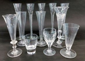 A set of five glasses, each with an air twist stem, and other glasses.