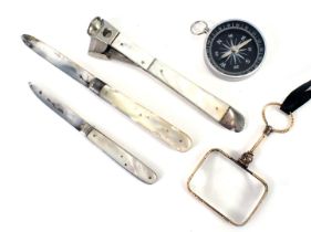 A mother of pearl handled and steel pen knife, a mother of pearl steel cigar cutter, a gilt handled