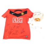 A signed Manchester United 1999 treble winners football and a Manchester United shirt. (2)