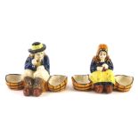 A pair of 1930s/40s Quimper Faience salts, each modelled in the form of a lady and a gentleman, each