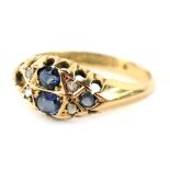 An 18ct gold gypsy ring, set with four oval sapphires (1 missing) and four tiny diamonds, each in cl