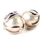 A pair of pearl and diamond cluster earrings, blister pearl centre in modern white gold design, set