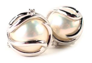 A pair of pearl and diamond cluster earrings, blister pearl centre in modern white gold design, set