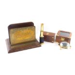 An oak and brass letter or stationary rack, engraved Papers, 26cm wide, an Indian brass telescope in