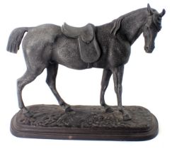 A cast spelter figure of a standing horse, on painted mottled decoration, on oval base, 25cm high. (