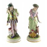 A pair of German porcelain figures, modelled in the form of a lady and gentleman in 18thC dress, wit