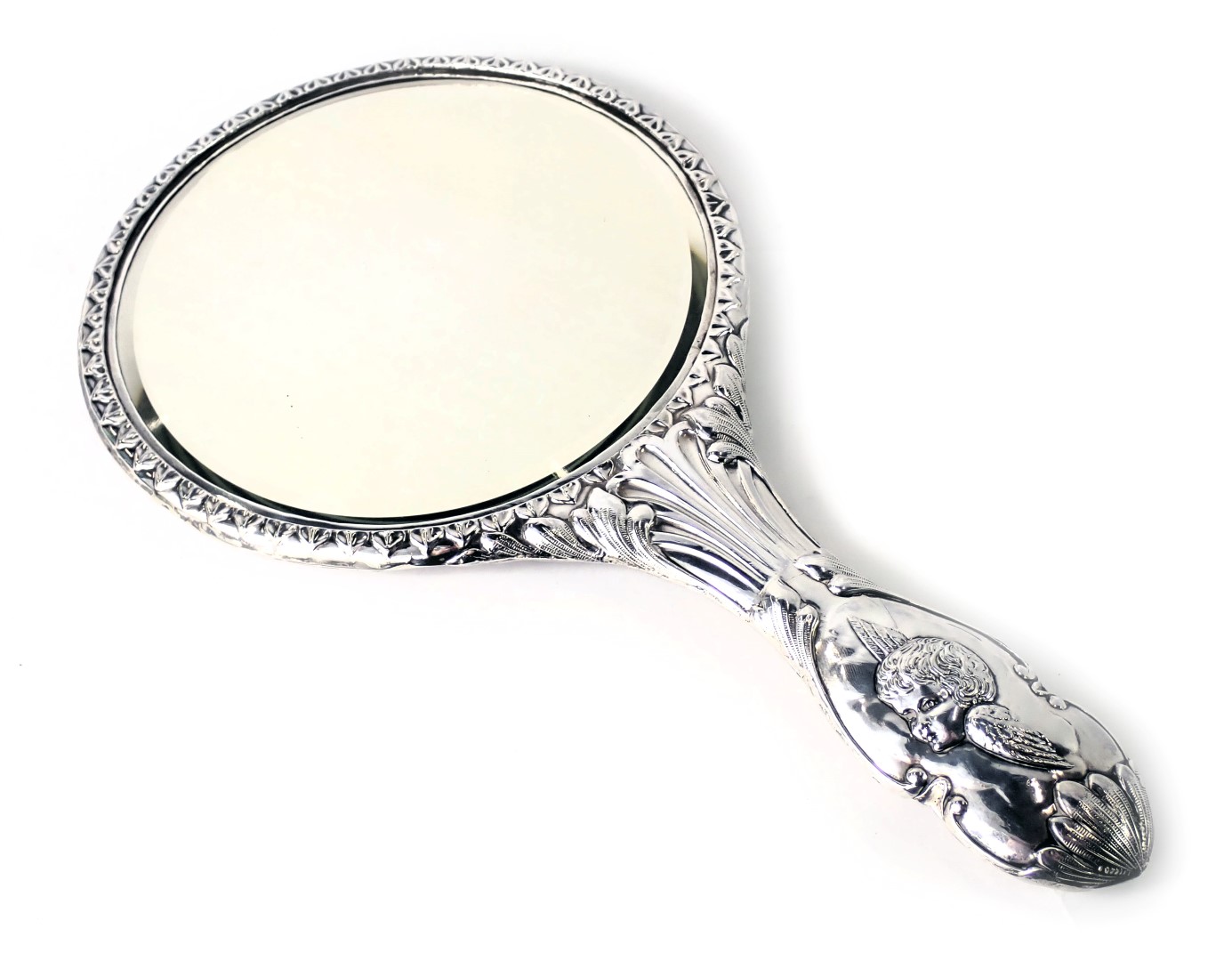 A George V silver backed dressing table mirror, with embossed children with wings, and scroll handle