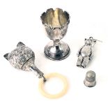 A small group of silver wares, comprising a silver egg cup, with weighted base, and fluted top, Ches