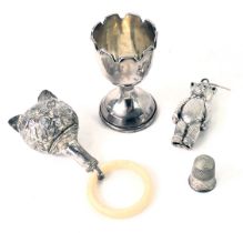 A small group of silver wares, comprising a silver egg cup, with weighted base, and fluted top, Ches