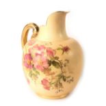 A Royal Worcester porcelain blush ivory ground ewer, decorated with pink and purple flowers and leav