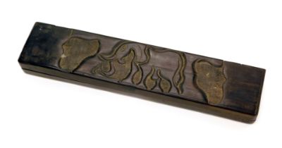 A carved African ebony game, the hinged lid decorated with an elephant enclosing marble type counter